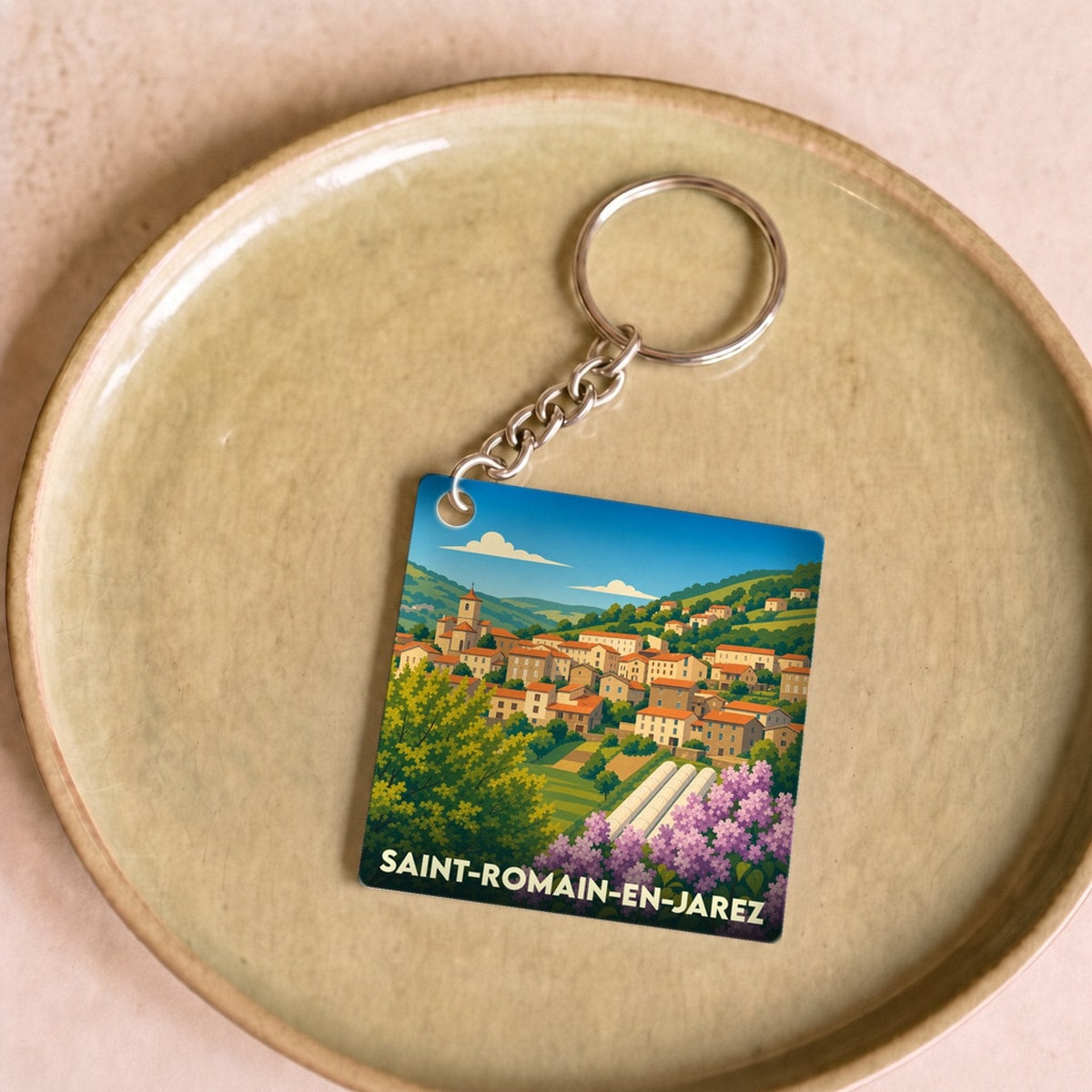 Porte-clés souvenir de la ville de Saint-Romain-en-Jarez avec une illustration stylisée.