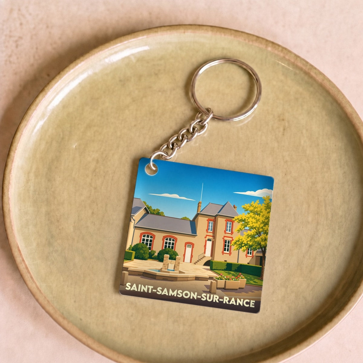 Porte-clés souvenir de la ville de Saint-Samson-sur-Rance avec une illustration stylisée.