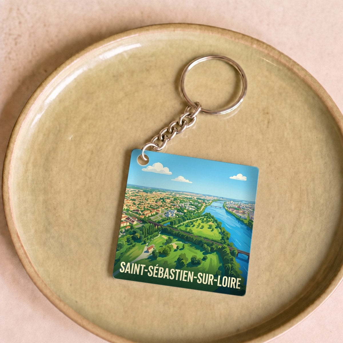 Porte-clés souvenir de la ville de Saint-Sébastien-sur-Loire avec une illustration stylisée.