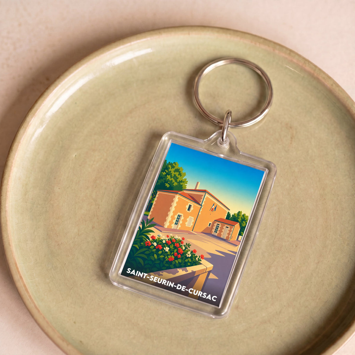 Porte-clés souvenir de la ville de Saint-Seurin-de-Cursac avec une illustration stylisée.