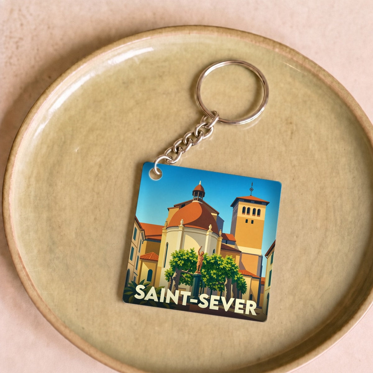 Porte-clés souvenir de la ville de Saint-Sever avec une illustration stylisée.