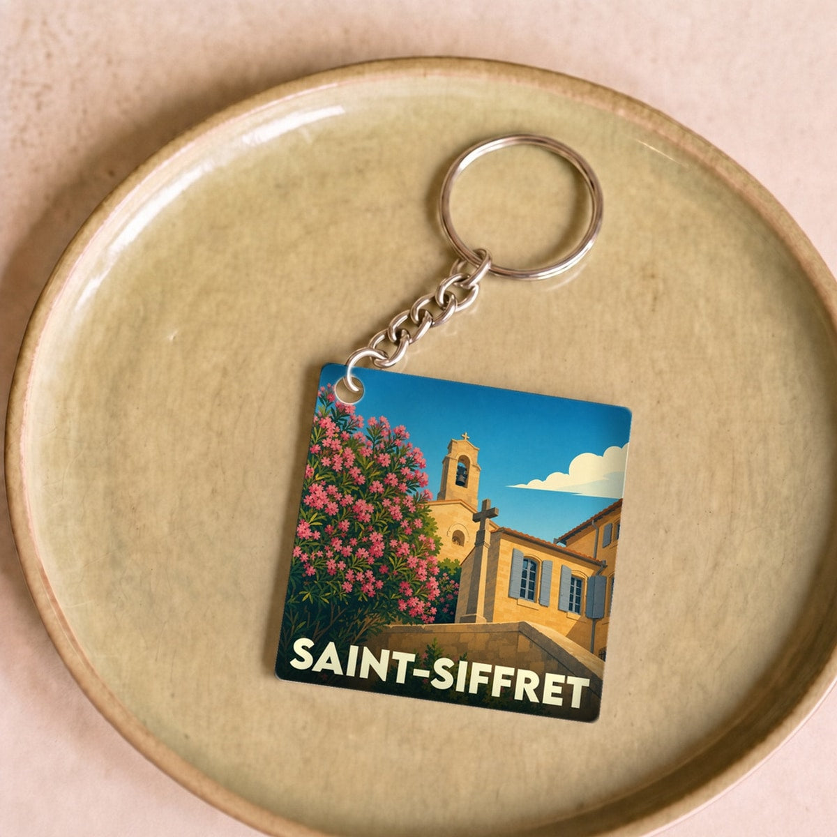 Porte-clés souvenir de la ville de Saint-Siffret avec une illustration stylisée.