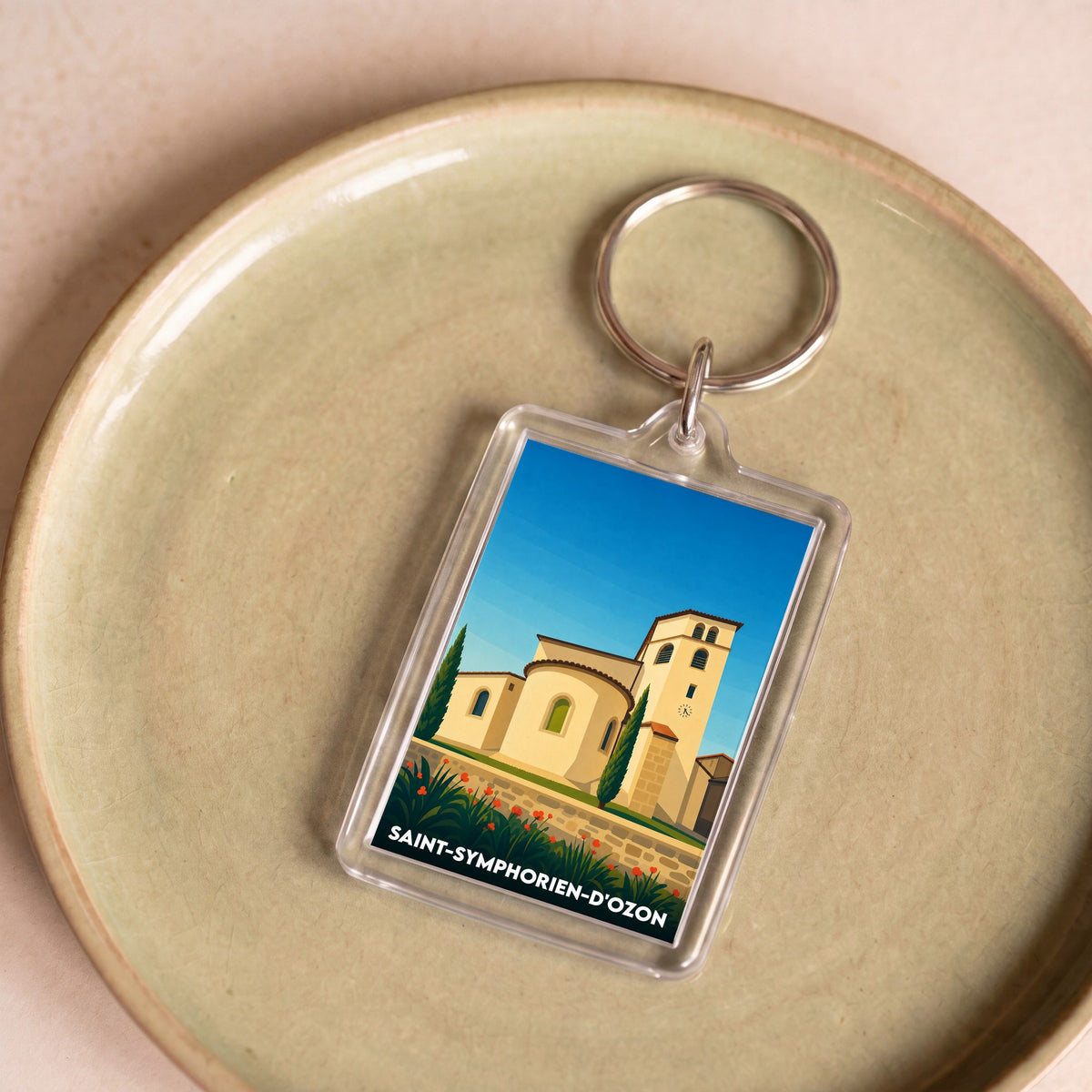 Porte-clés souvenir de la ville de Saint-Symphorien-d'Ozon avec une illustration stylisée de son église.