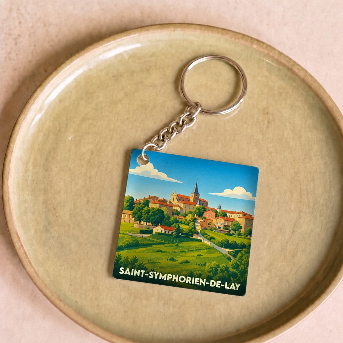 Porte-clés souvenir de la ville de Saint-Symphorien-de-Lay avec une illustration stylisée.