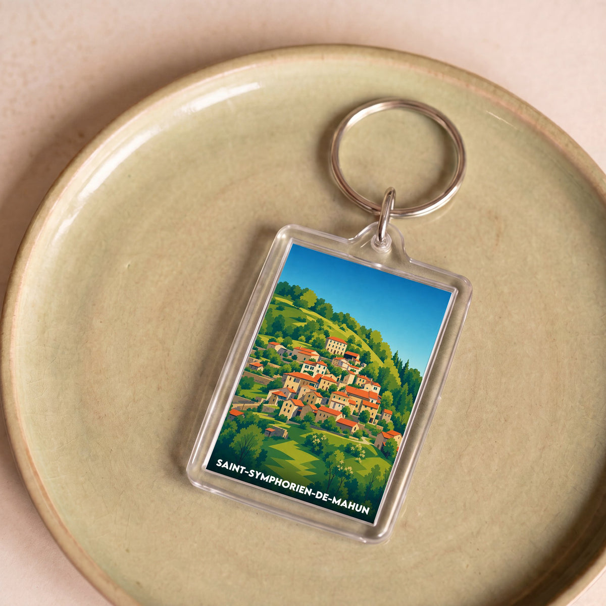 Porte-clés souvenir de la ville de Saint-Symphorien-de-Mahun avec une illustration stylisée du village.