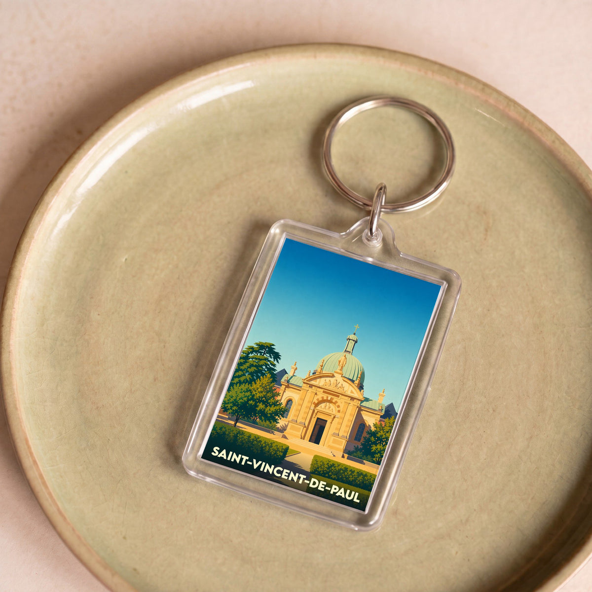 Porte-clés souvenir de la ville de Saint-Vincent-de-Paul avec une illustration stylisée de son église.