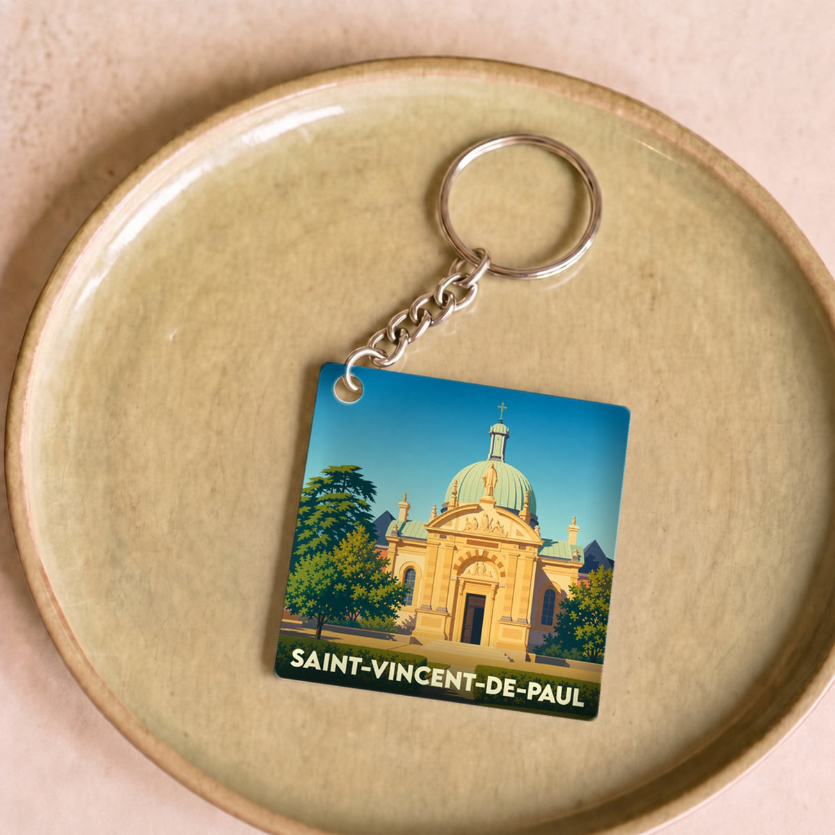 Porte-clés souvenir de la ville de Saint-Vincent-de-Paul avec une illustration stylisée de son église.