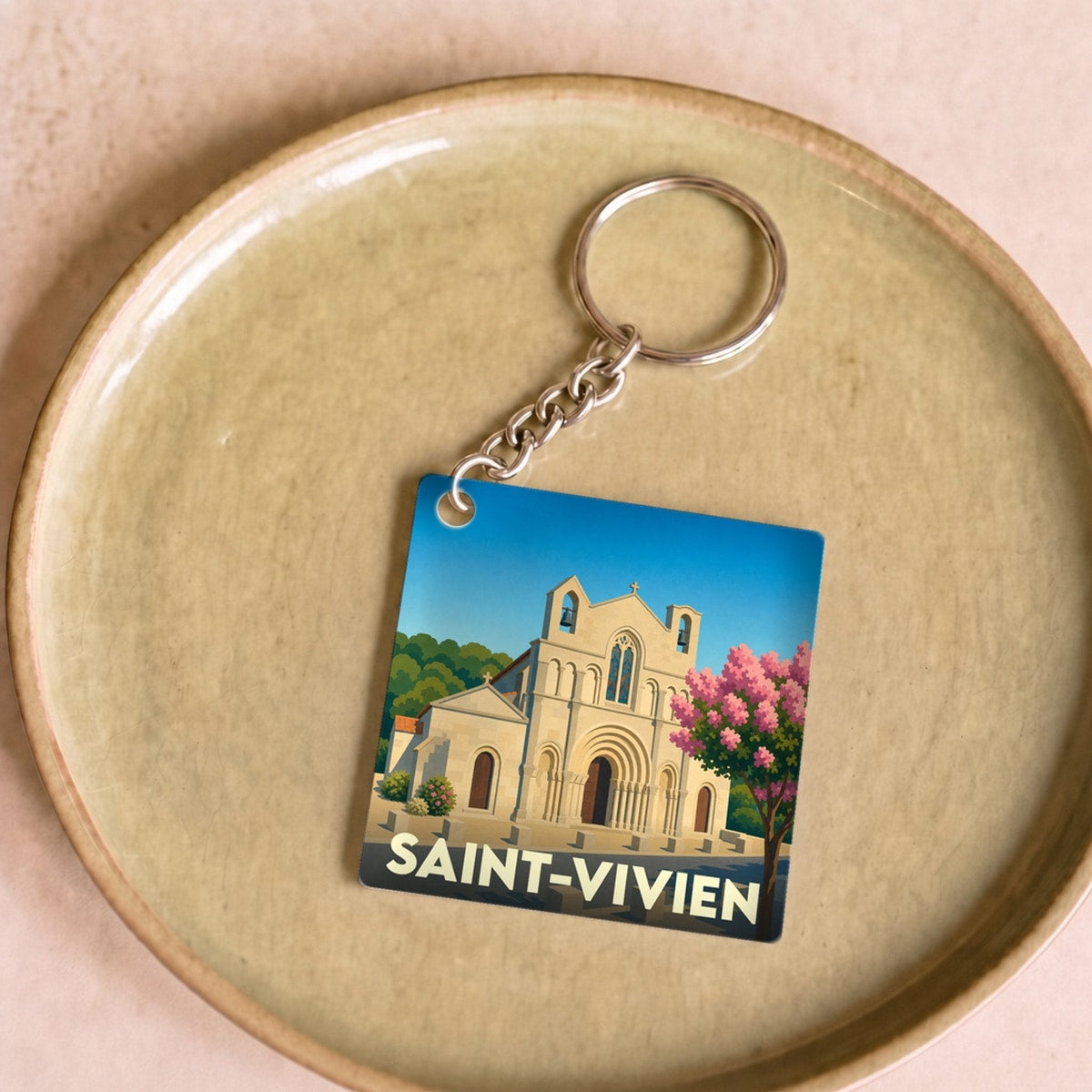 Porte-clés souvenir de la ville de Saint-Vivien avec une illustration stylisée de son église.