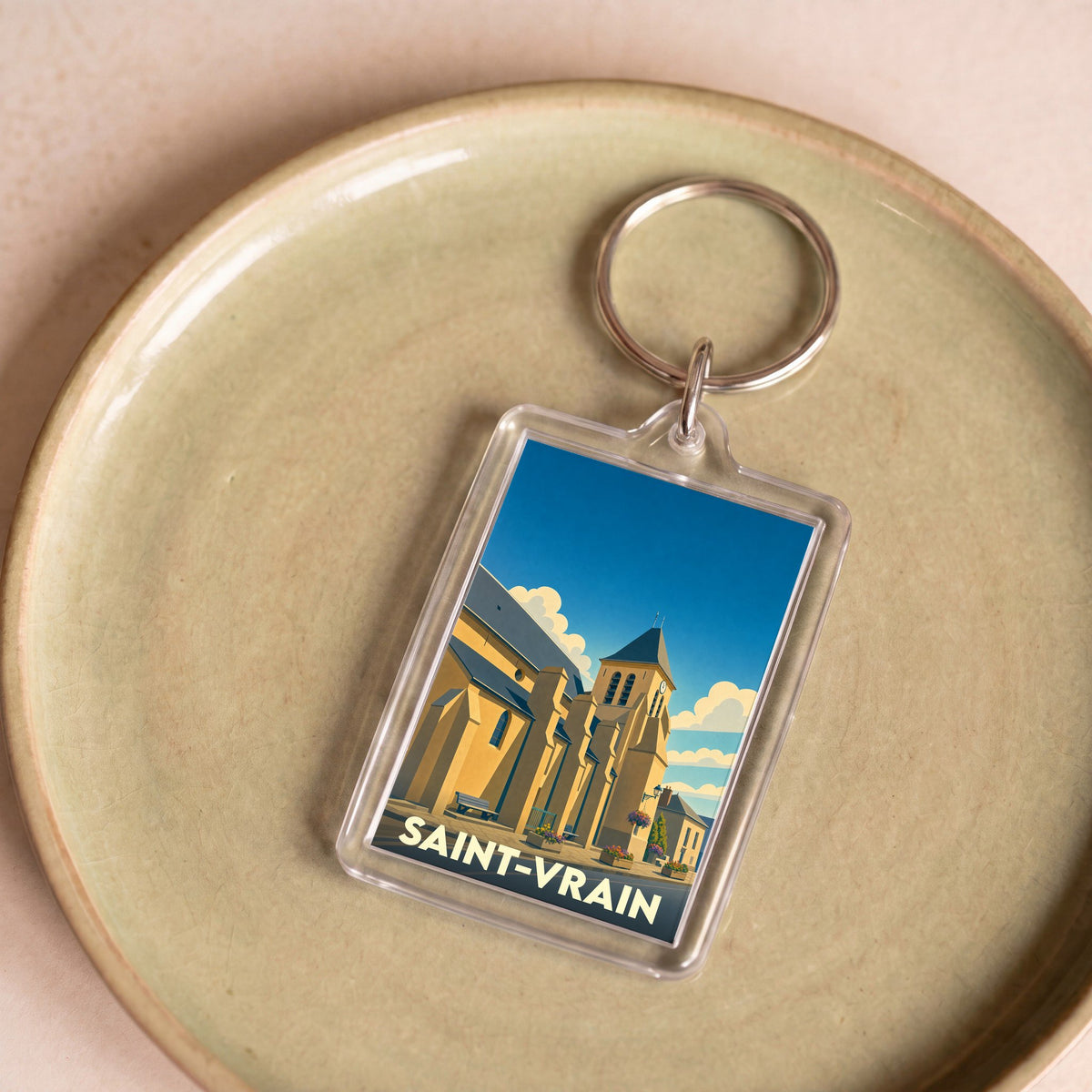 Porte-clés souvenir de la ville de Saint-Vrain avec une illustration stylisée de son église.