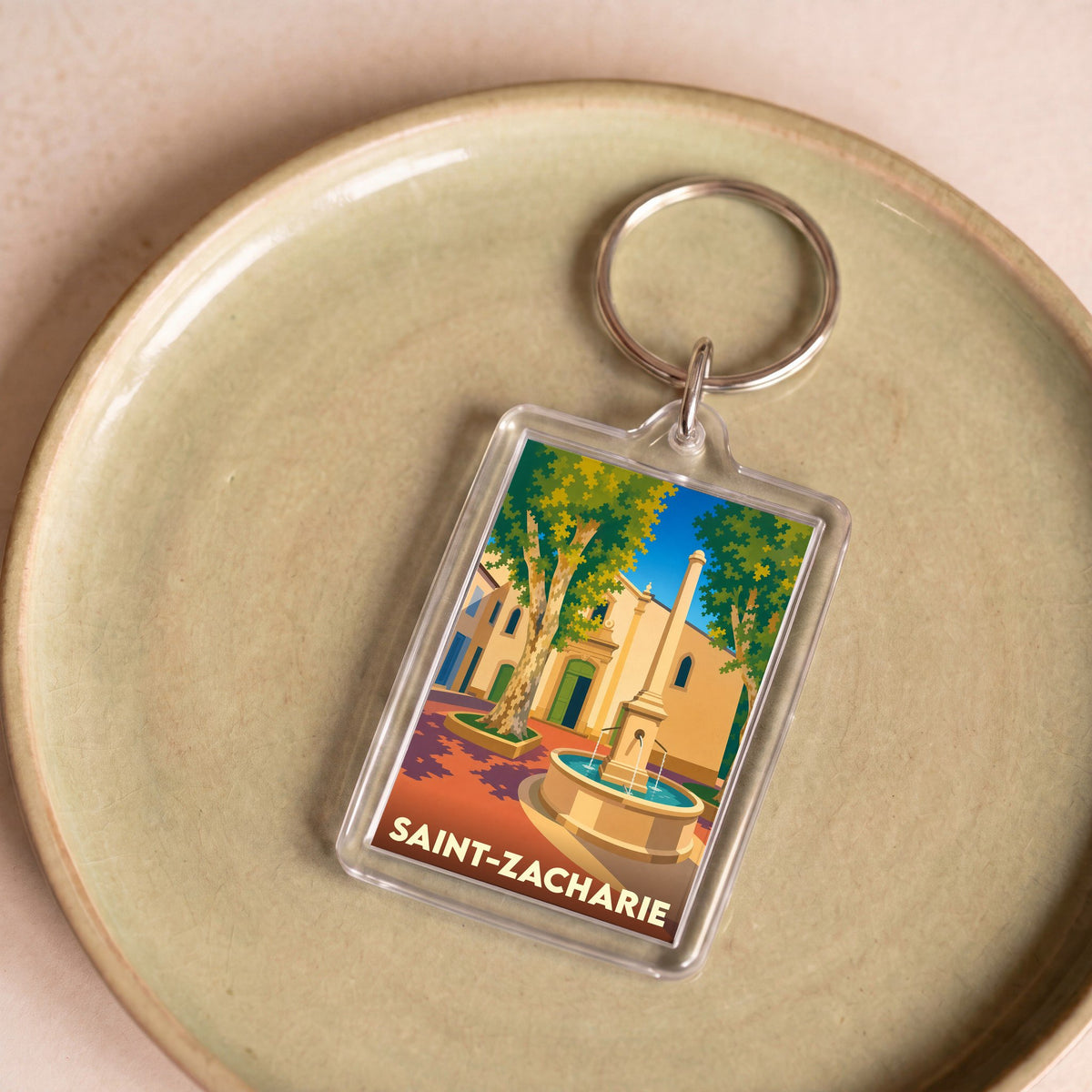 Porte-clés souvenir de la ville de Saint-Zacharie avec une illustration stylisée.