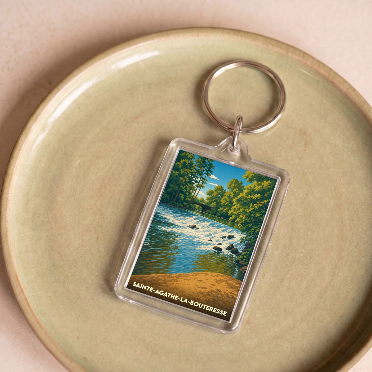 Porte-clés souvenir de la ville de Sainte-Agathe-la-Bouteresse avec une illustration stylisée.
