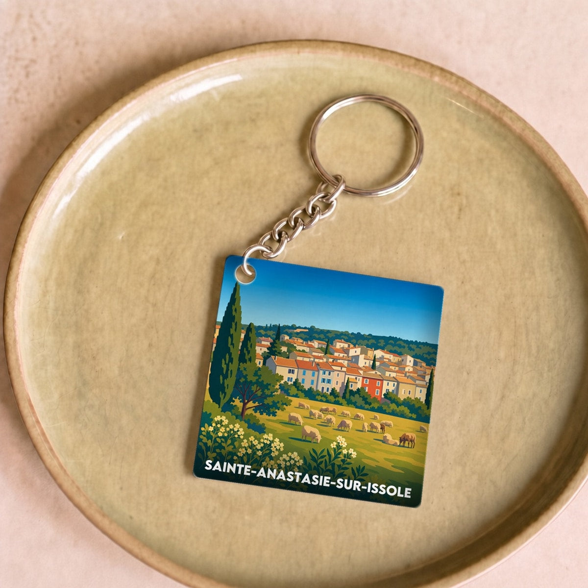 Porte-clés souvenir de la ville de Sainte-Anastasie-sur-Issole avec une illustration stylisée.