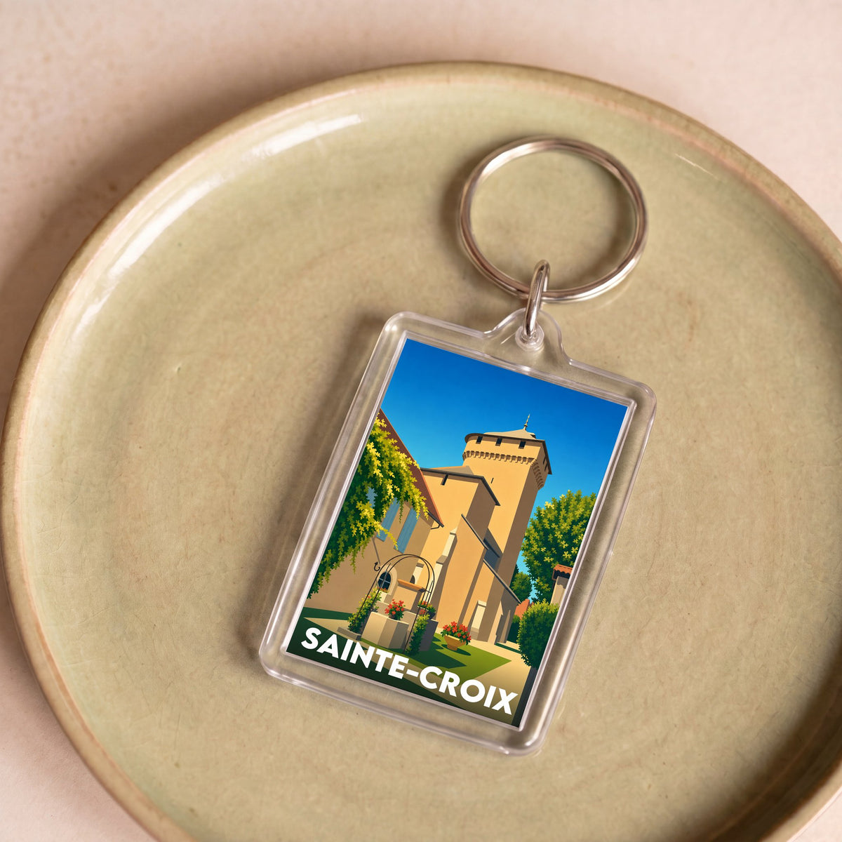 Porte-clés souvenir de la ville de Sainte-Croix avec une illustration stylisée.