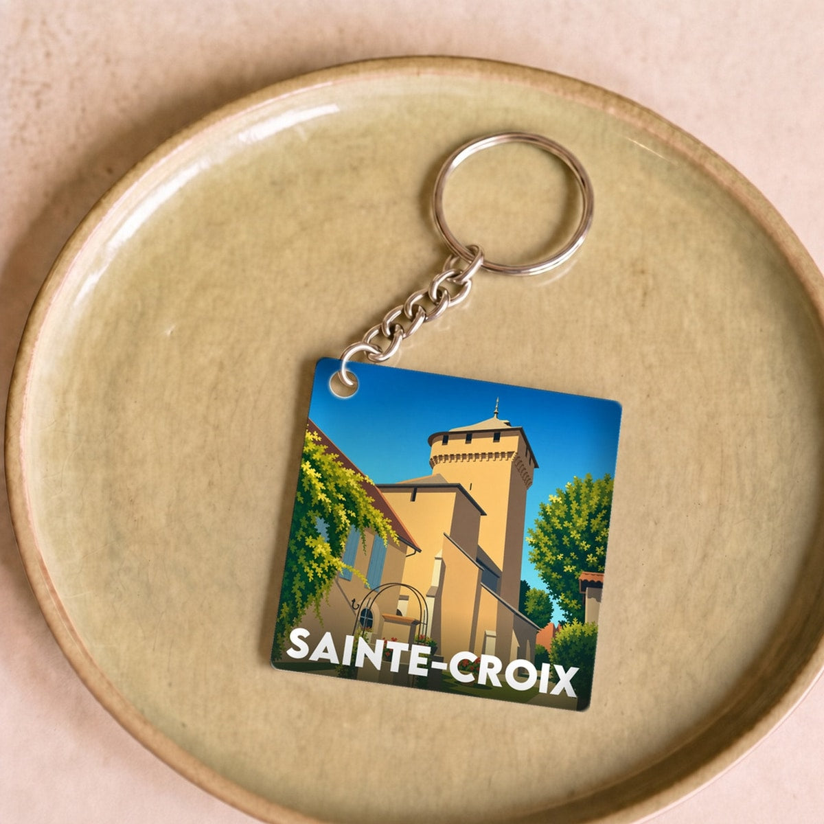 Porte-clés souvenir de la ville de Sainte-Croix avec une illustration stylisée.