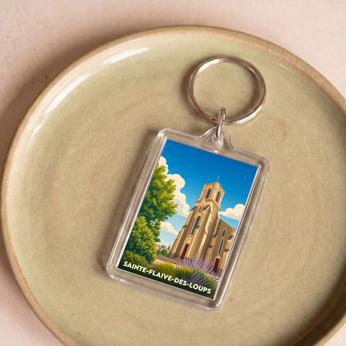Porte-clés souvenir de la ville de Sainte-Flaive-des-Loups avec une illustration stylisée de son église.