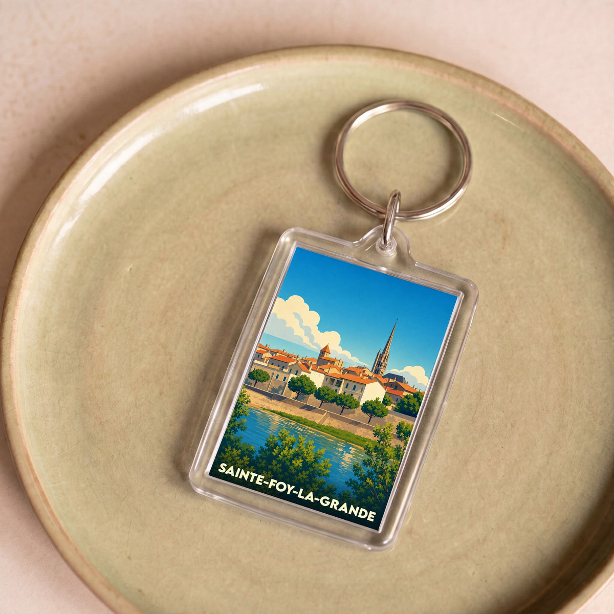 Porte-clés souvenir de la ville de Sainte-Foy-la-Grande avec une illustration stylisée.