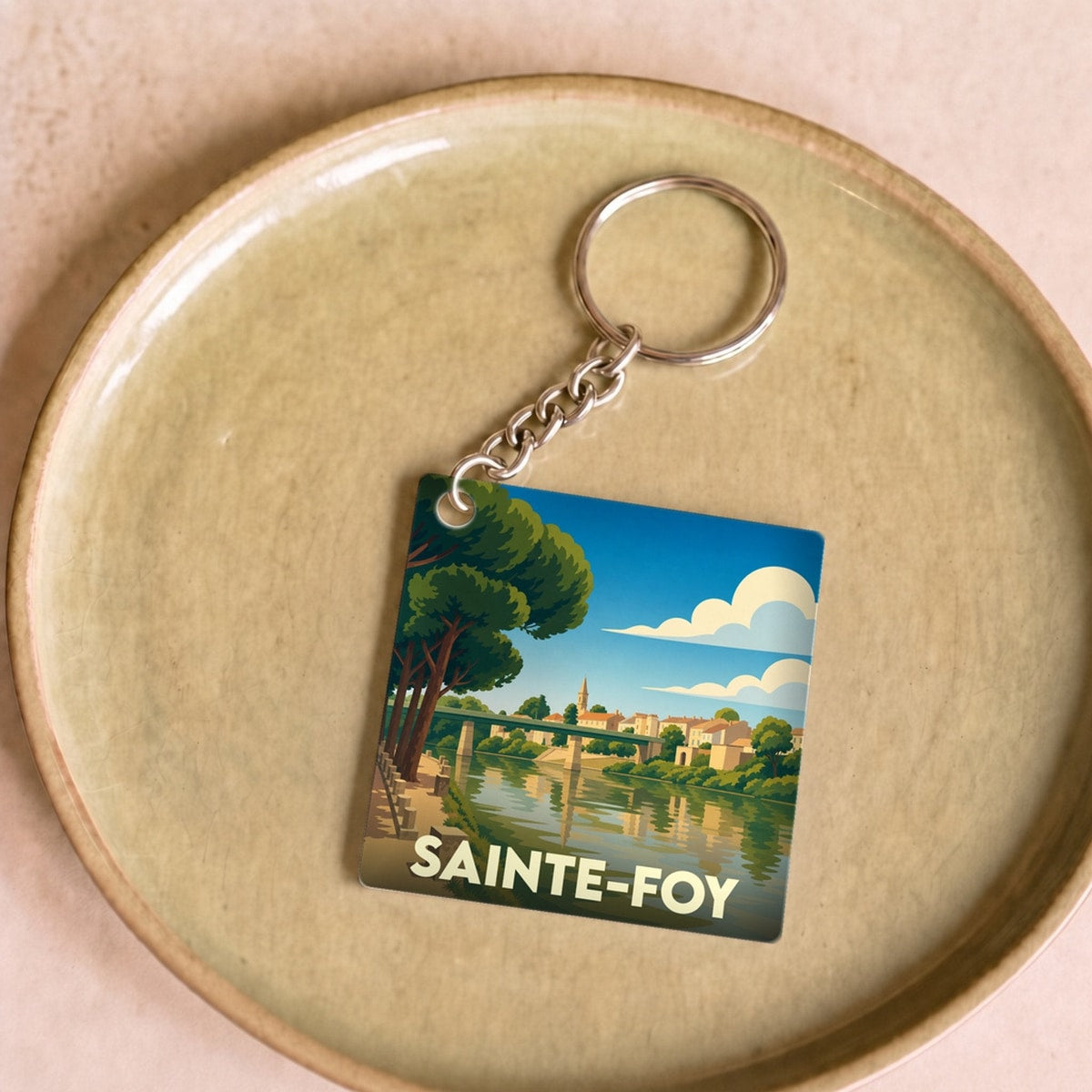 Porte-clés souvenir de la ville de Sainte-Foy avec une illustration stylisée.