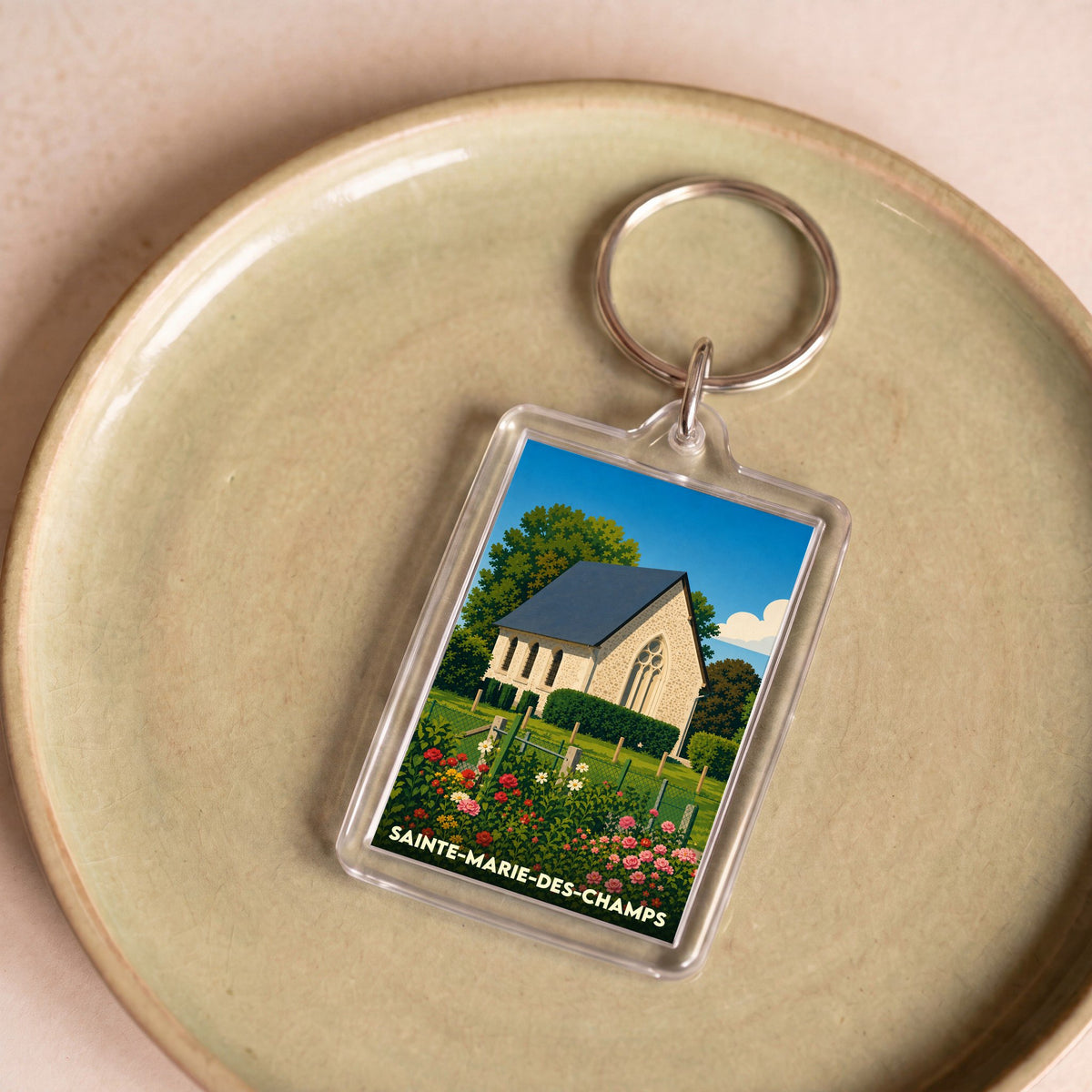 Porte-clés souvenir de la ville de Sainte-Marie-des-Champs avec une illustration stylisée d'une église.