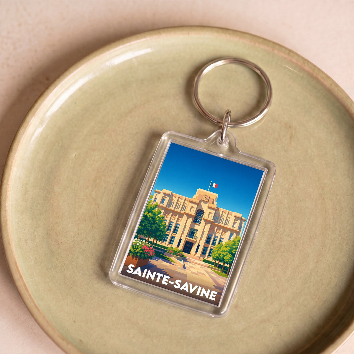 Porte-clés souvenir de la ville de Sainte-Savine avec une illustration stylisée de son hôtel de ville.