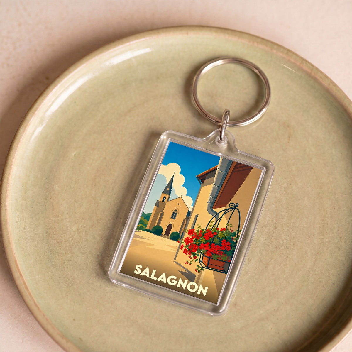 Porte-clés souvenir de la ville de Salagnon avec une illustration stylisée.