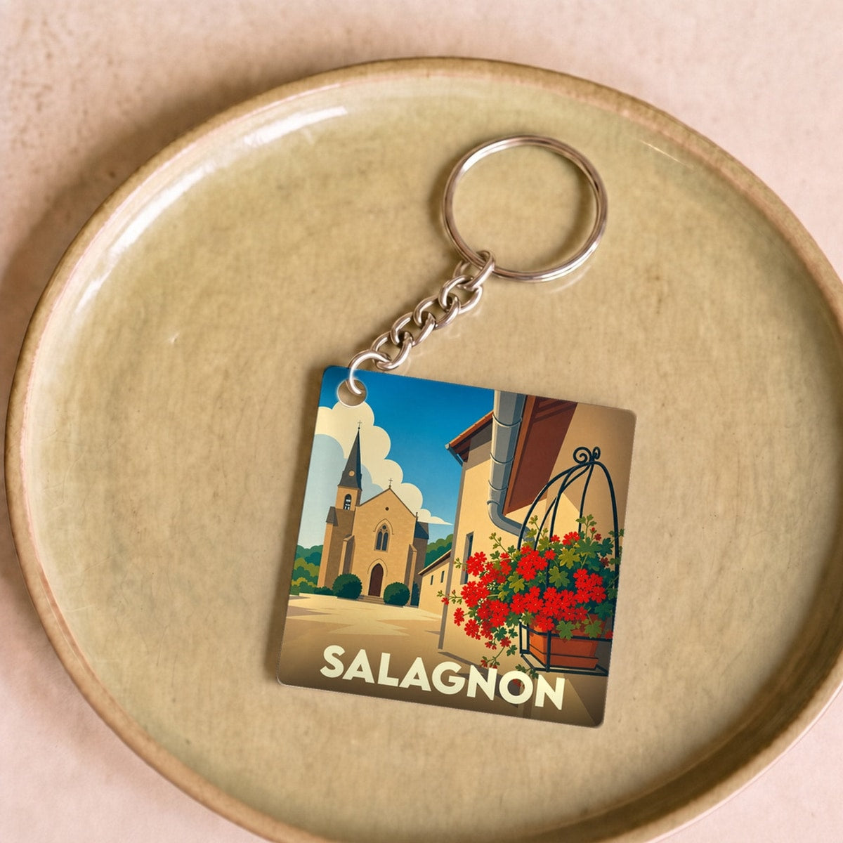 Porte-clés souvenir de la ville de Salagnon avec une illustration stylisée.