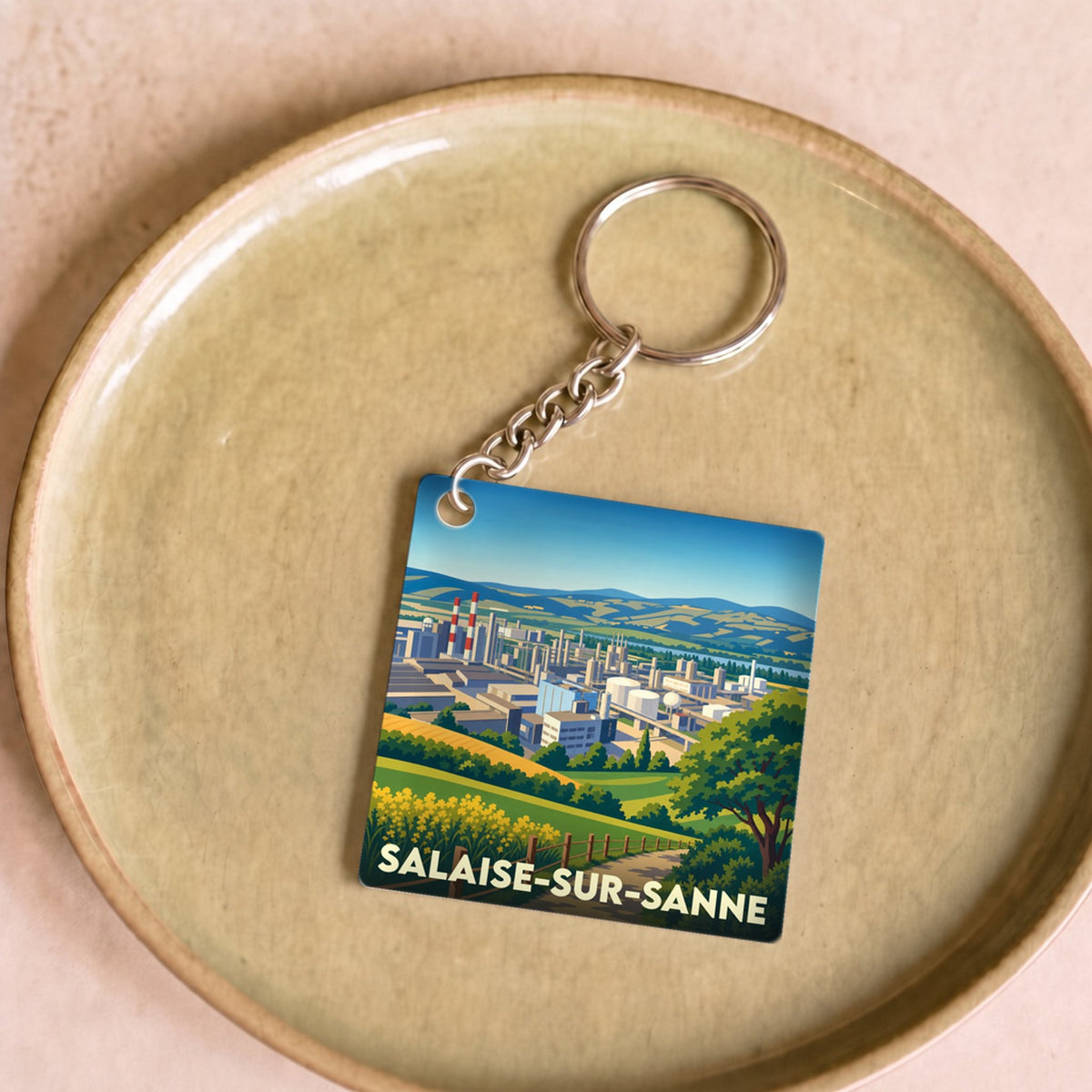 Porte-clés souvenir de la ville de Salaise-sur-Sanne avec une illustration stylisée.