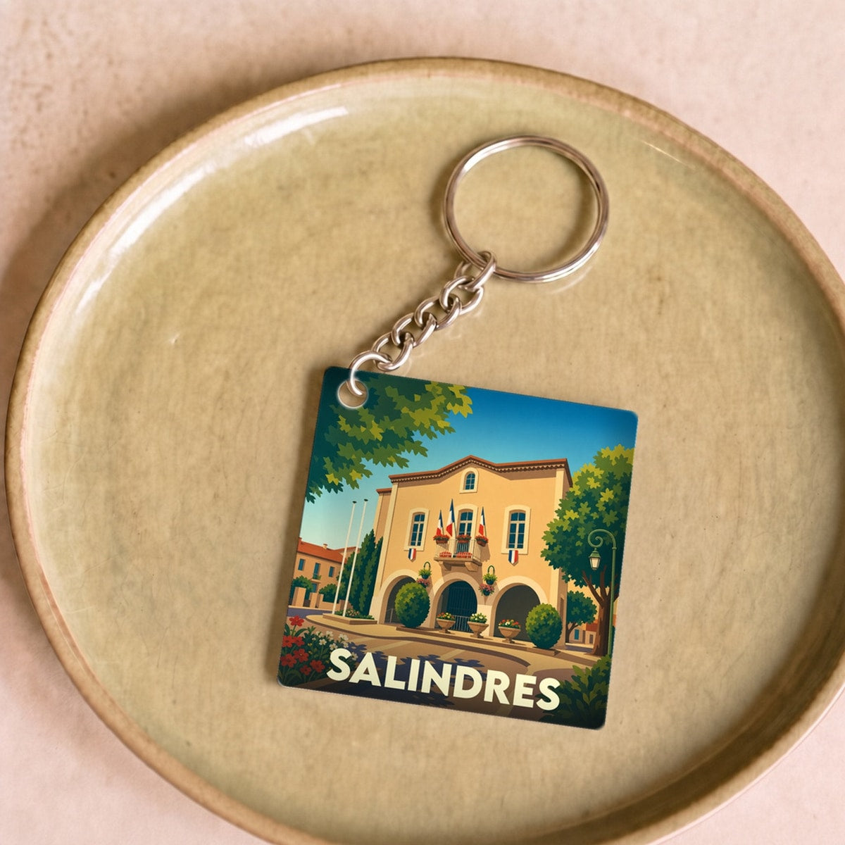 Porte-clés souvenir de la ville de Salindres avec une illustration stylisée.