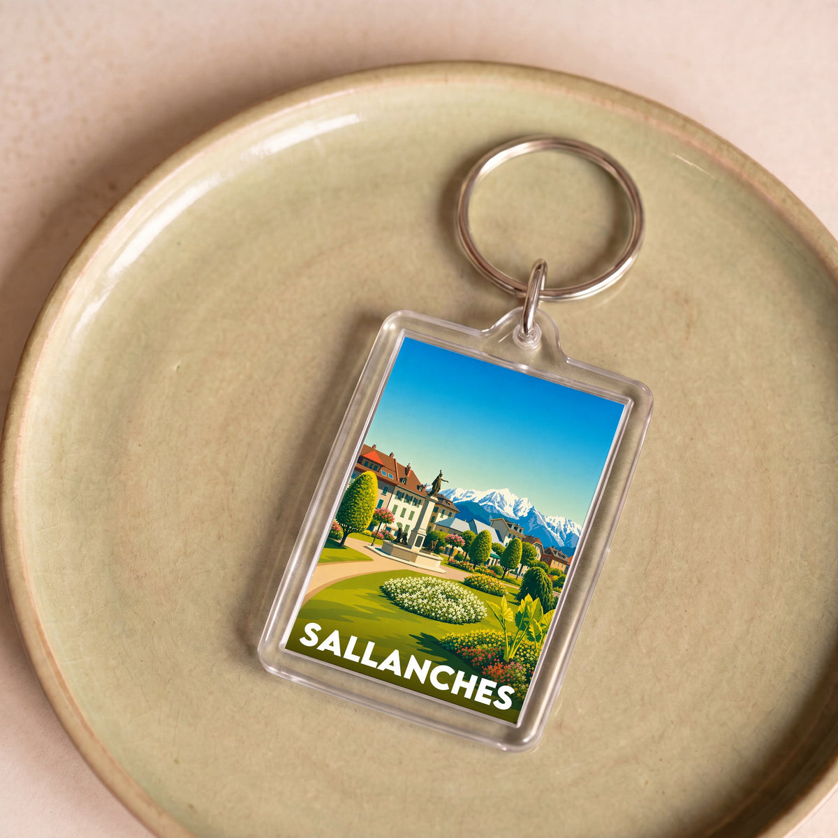 Porte-clés souvenir de la ville de Sallanches avec une illustration stylisée.