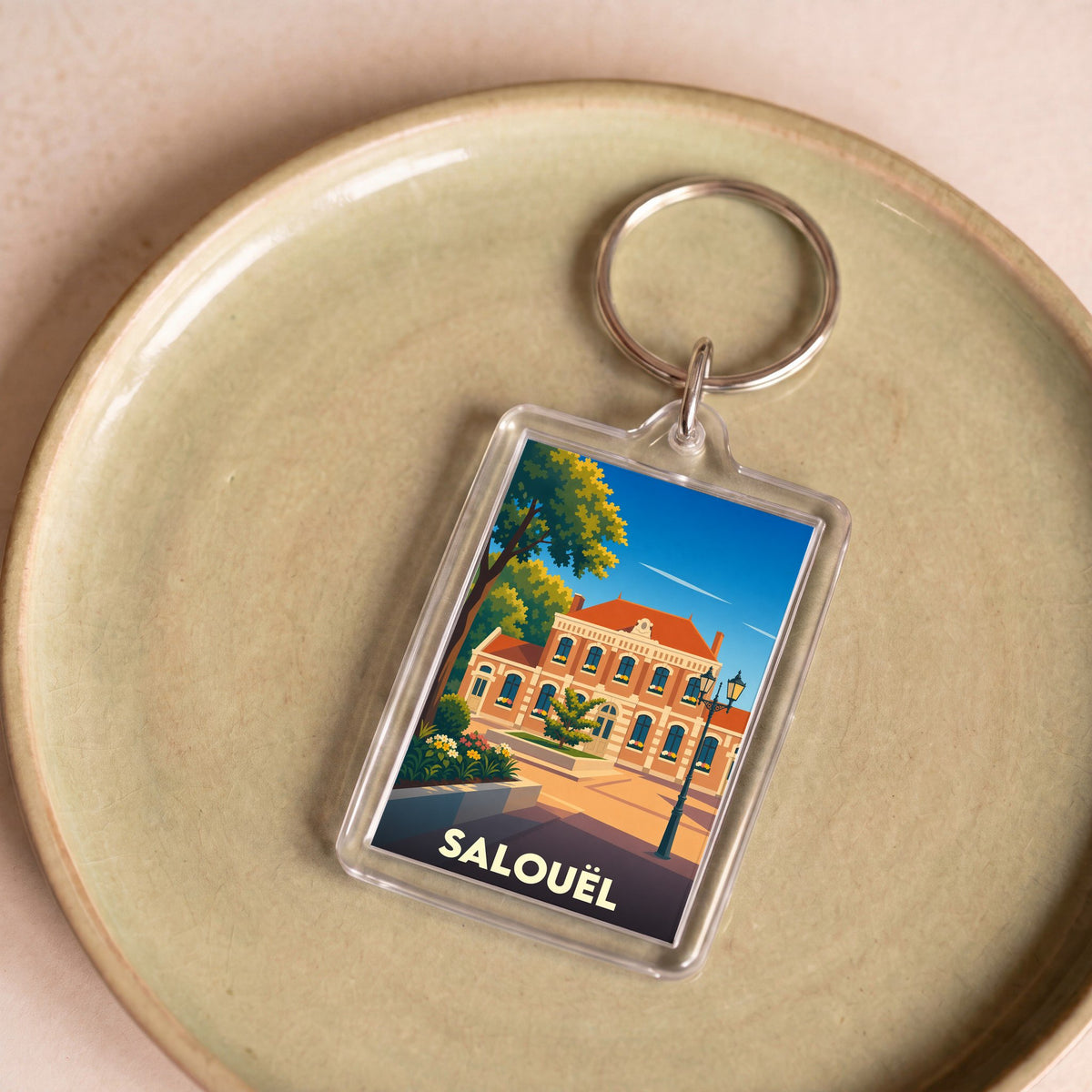 Porte-clés souvenir de la ville de Salouël avec une illustration stylisée.