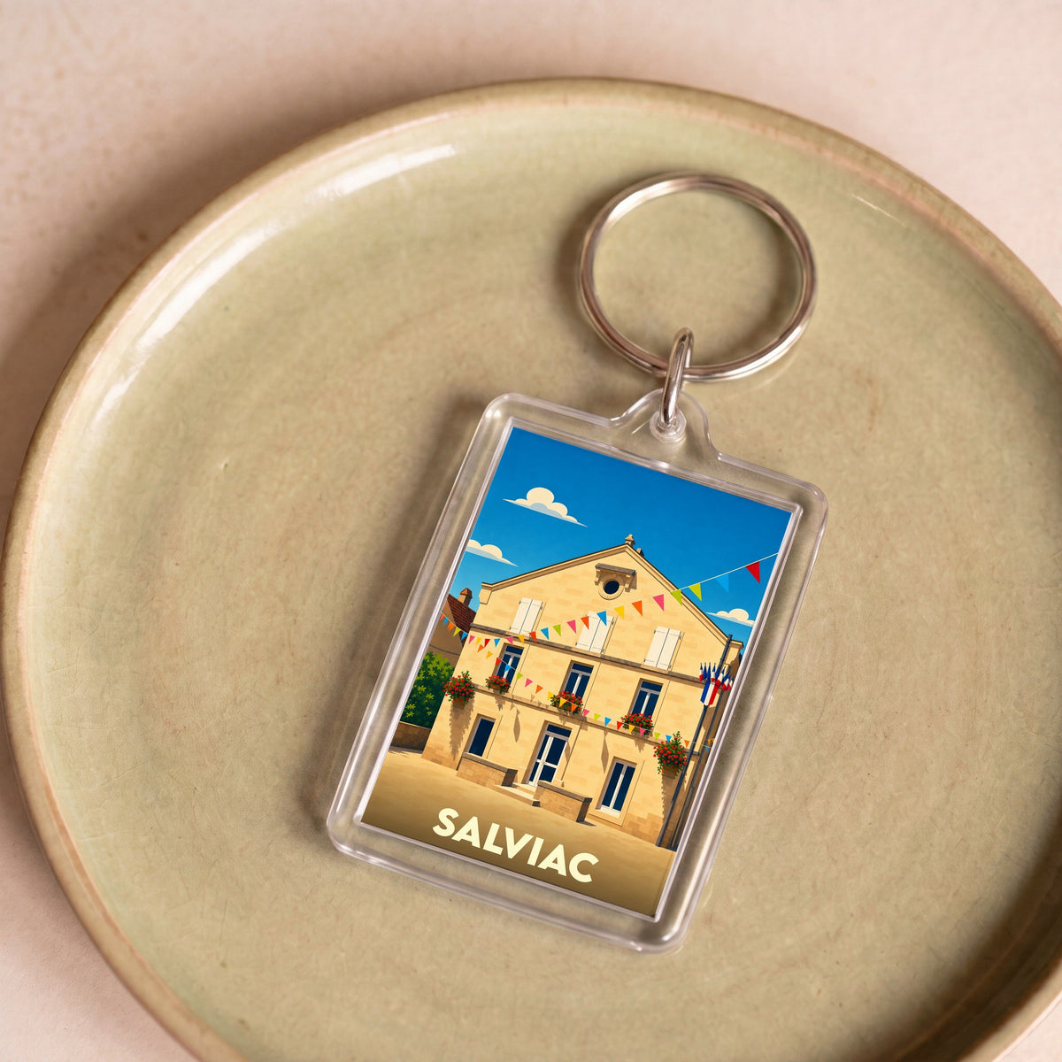 Porte-clés souvenir de la ville de Salviac avec une illustration stylisée.