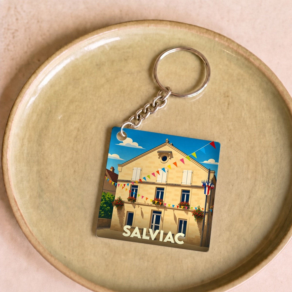 Porte-clés souvenir de la ville de Salviac avec une illustration stylisée.