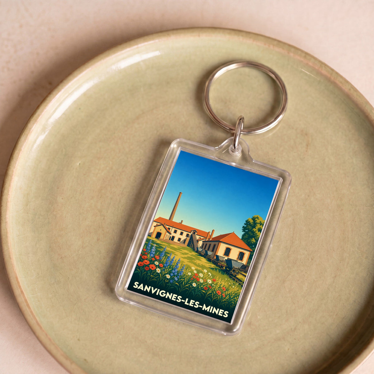 Porte-clés souvenir de la ville de Sanvignes-les-Mines avec une illustration stylisée de son patrimoine minier.