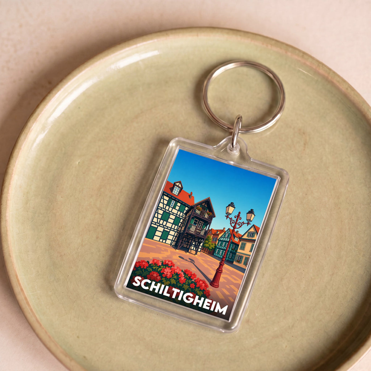 Porte-clés souvenir de la ville de Schiltigheim avec une illustration stylisée de son architecture traditionnelle.