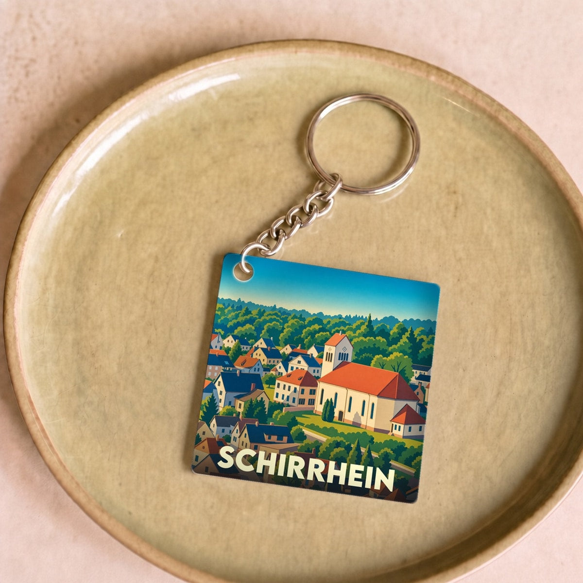 Porte-clés souvenir de la ville de Schirrhein avec une illustration stylisée.