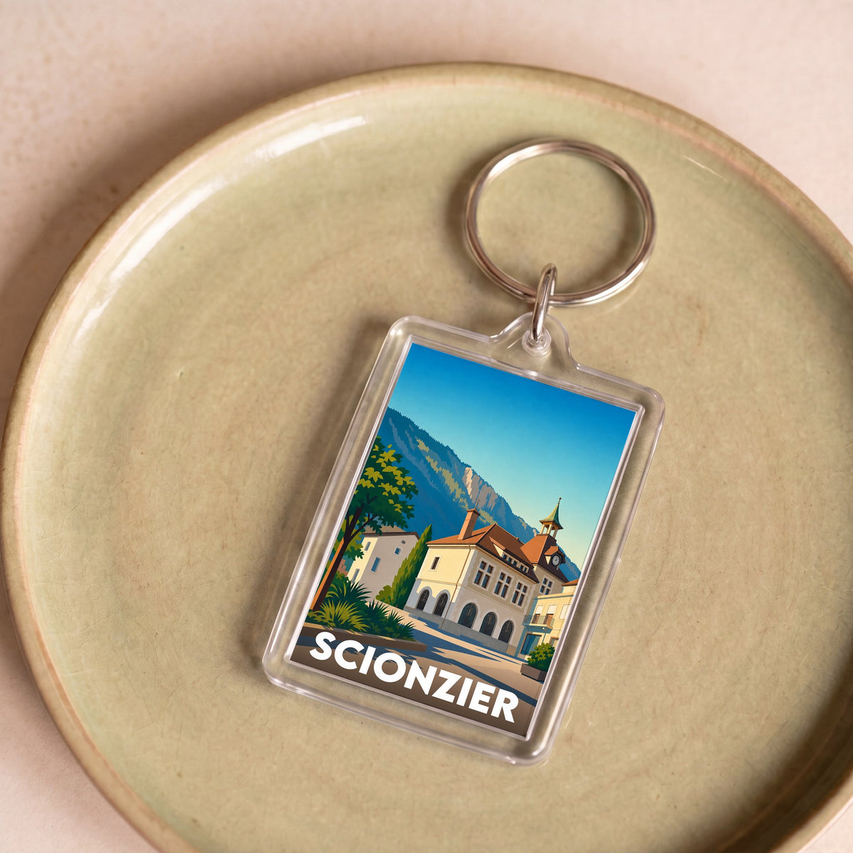 Porte-clés souvenir de la ville de Scionzier avec une illustration stylisée.