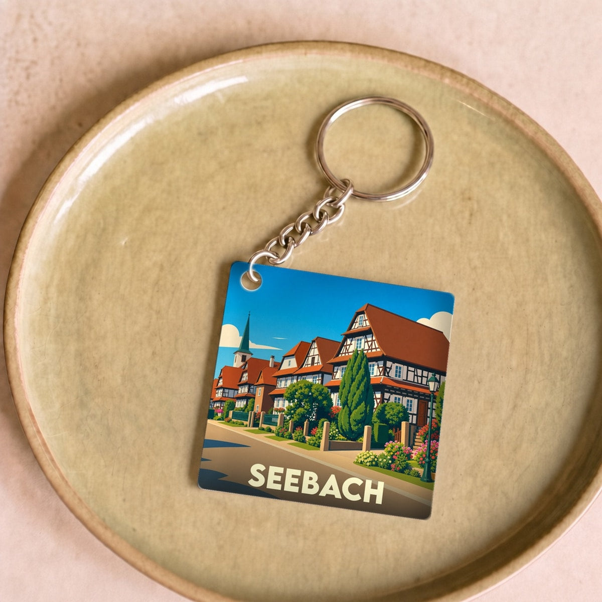 Porte-clés souvenir de la ville de Seebach avec une illustration stylisée de maisons à colombages.