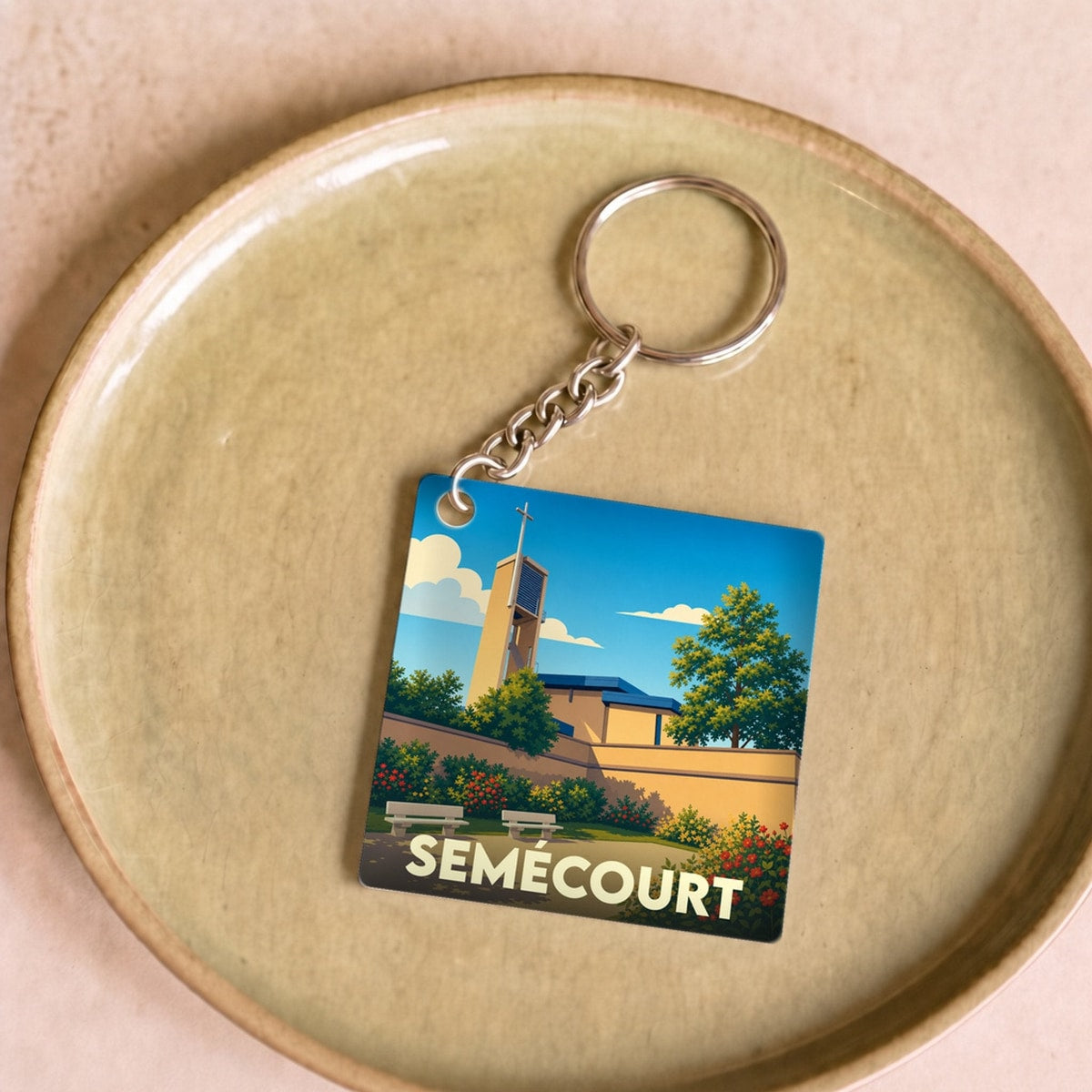 Porte-clés souvenir de la ville de Semécourt avec une illustration stylisée.