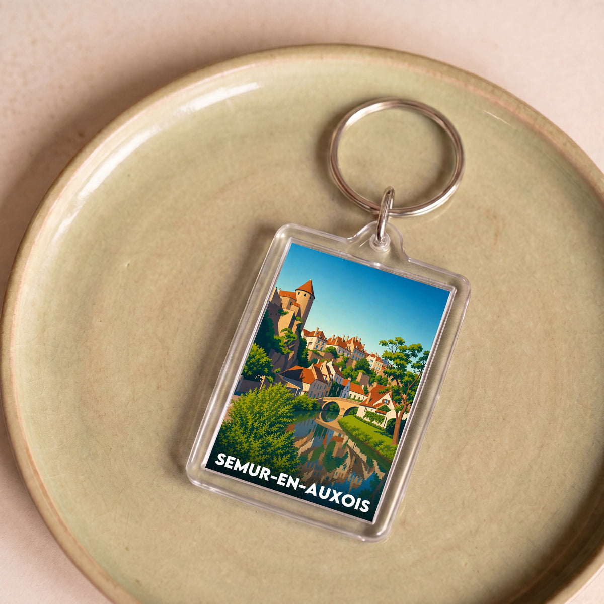 Porte-clés souvenir de la ville de Semur-en-Auxois avec une illustration stylisée.