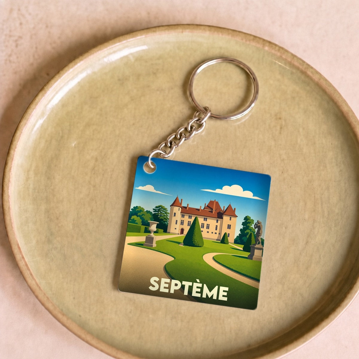 Porte-clés souvenir de la ville de Septème avec une illustration stylisée de son château.