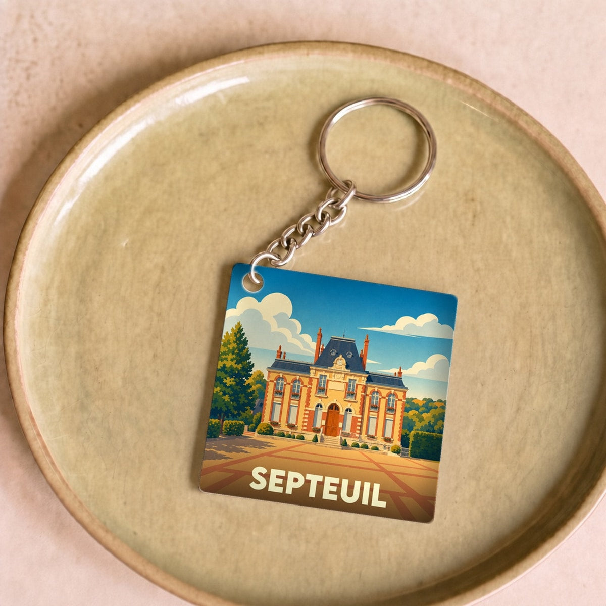 Porte-clés souvenir de la ville de Septeuil avec une illustration stylisée de son château.