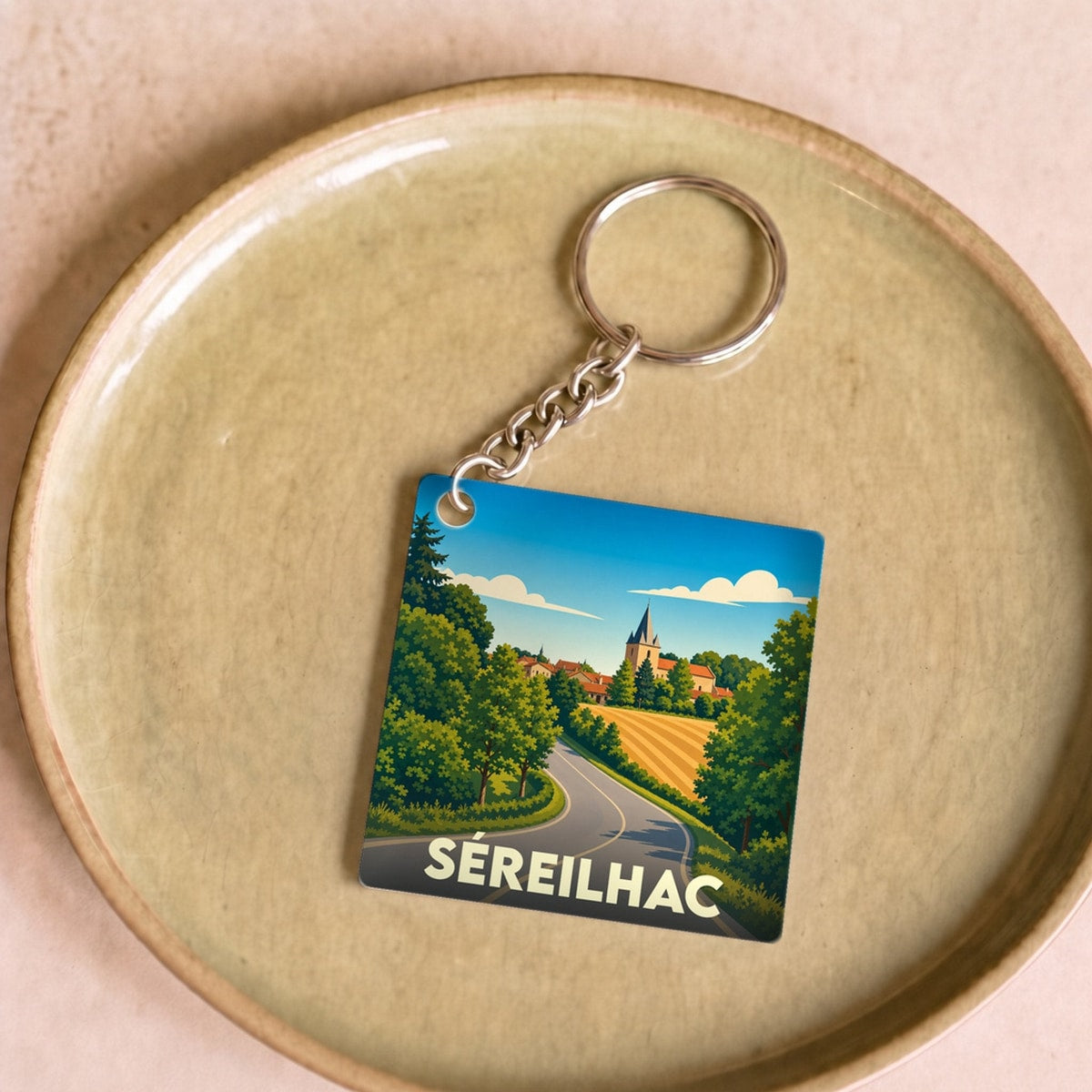 Porte-clés souvenir de la ville de Séreilhac avec une illustration stylisée.