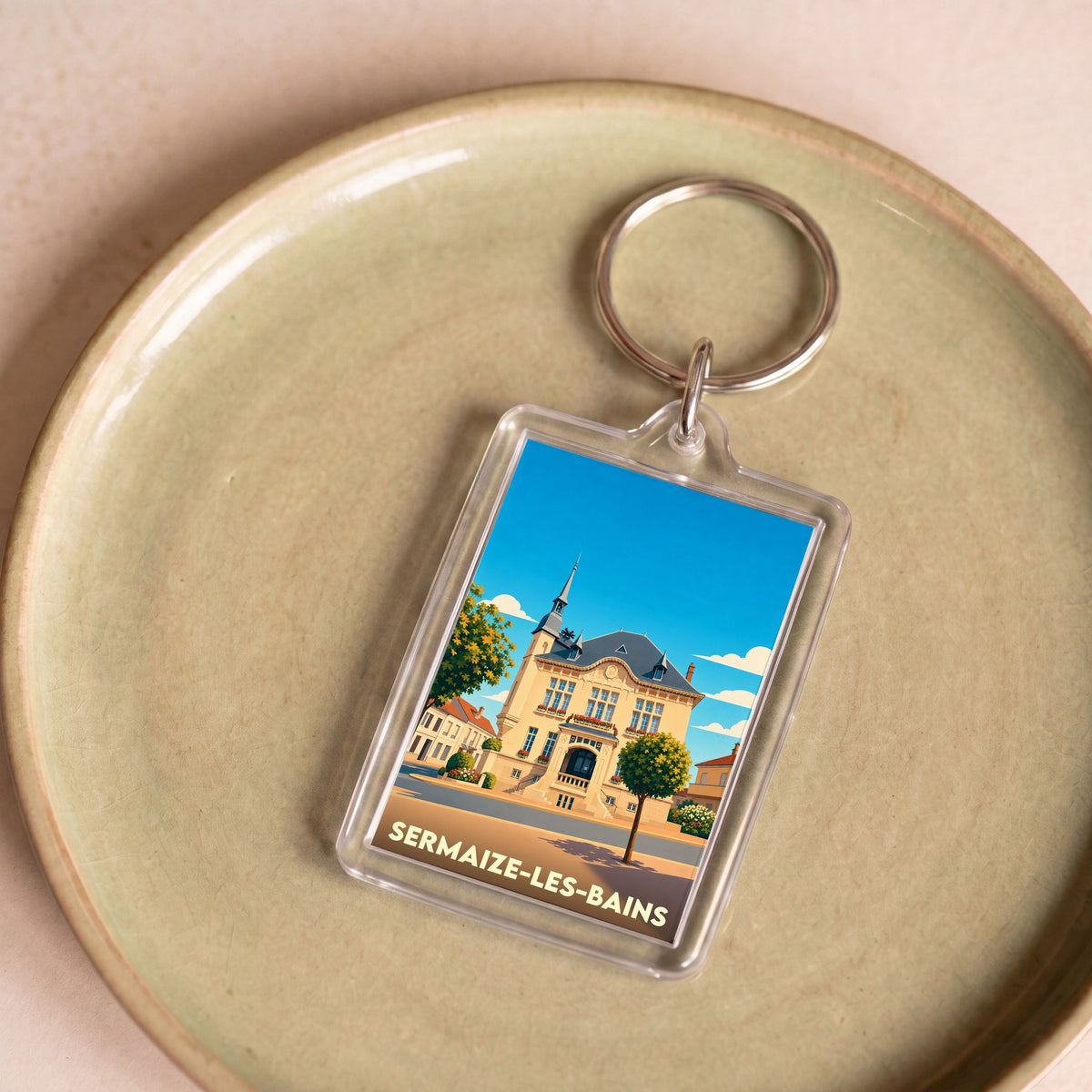 Porte-clés souvenir de la ville de Sermaize-les-Bains avec une illustration stylisée de son hôtel de ville.