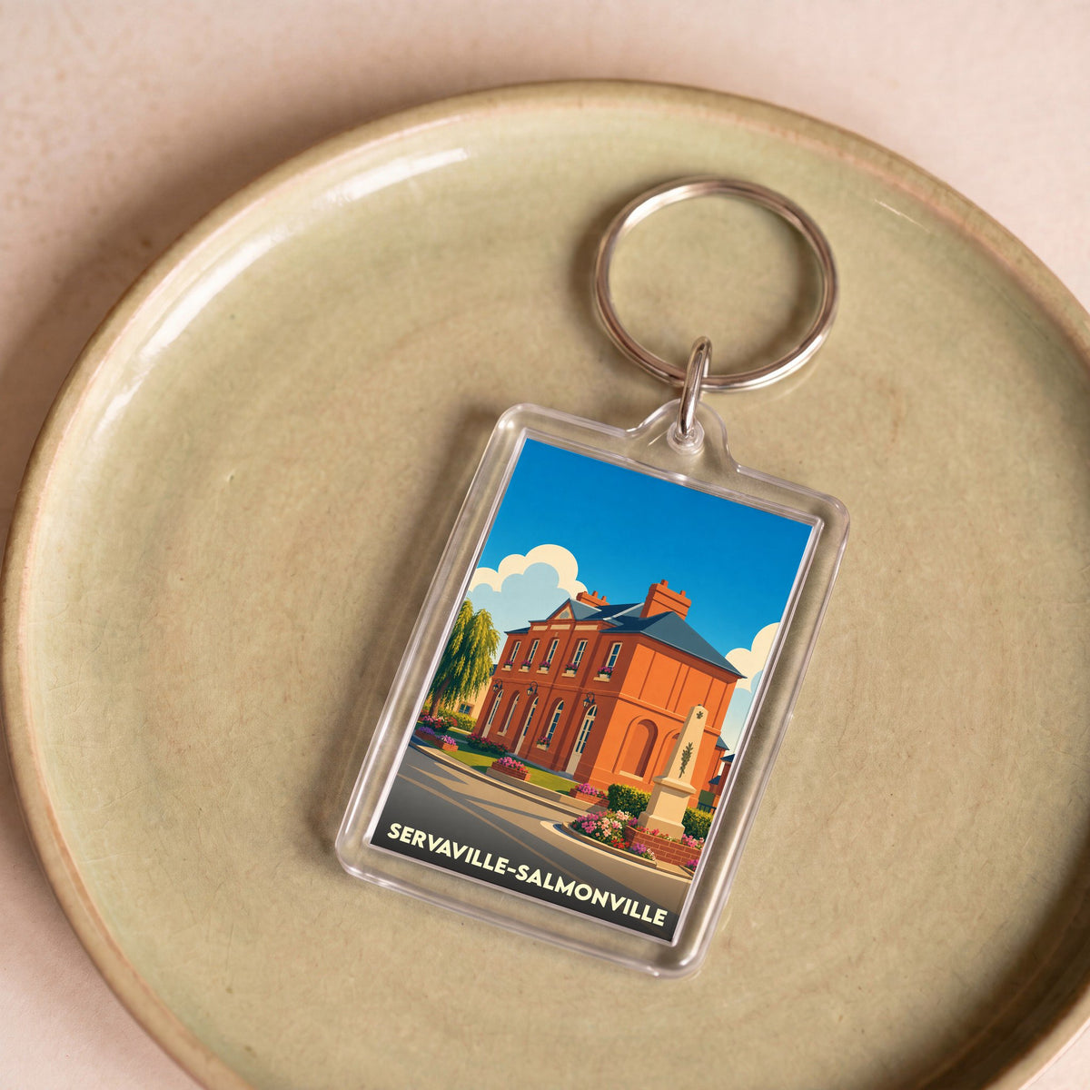 Porte-clés souvenir de la ville de Servaville-Salmonville avec une illustration stylisée.