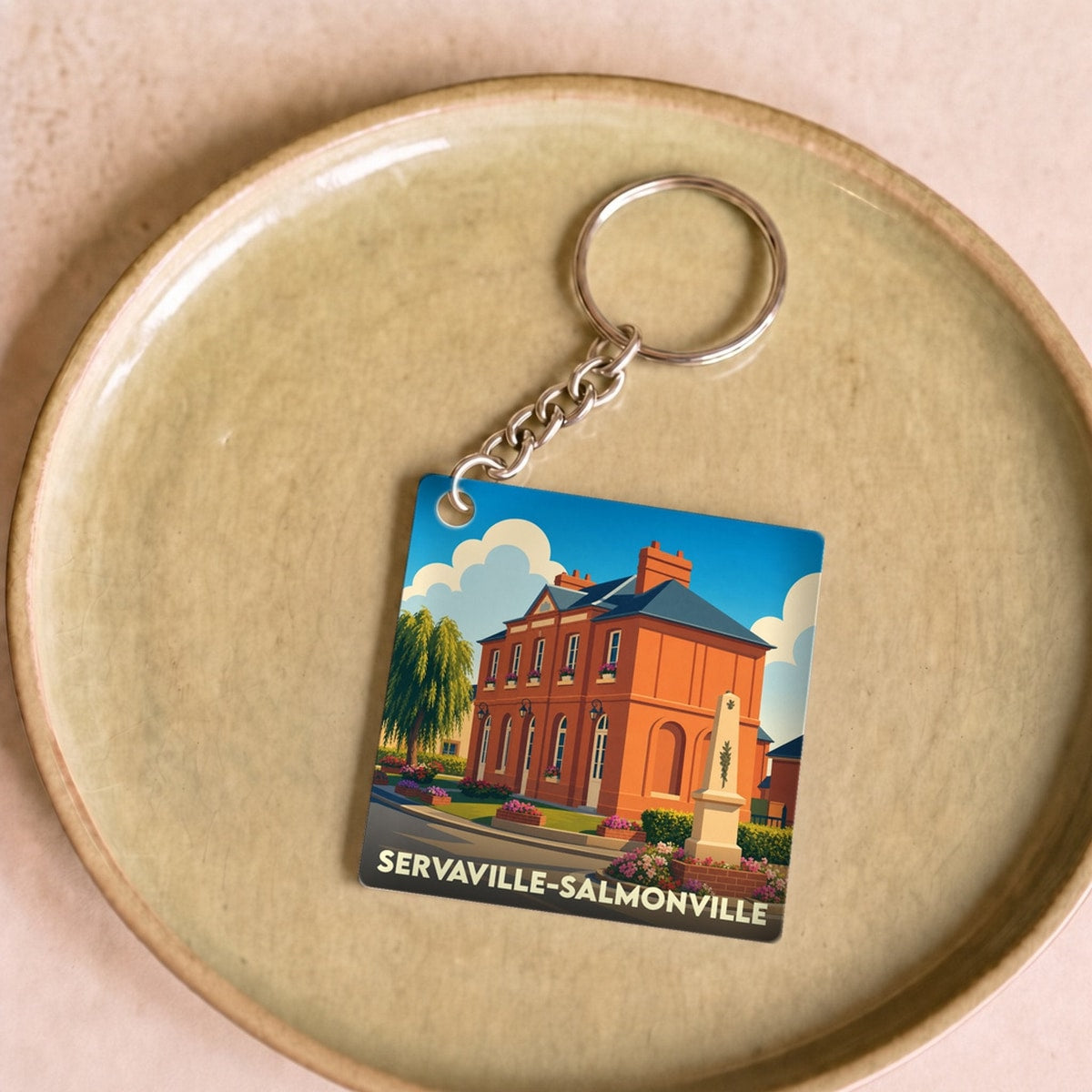 Porte-clés souvenir de la ville de Servaville-Salmonville avec une illustration stylisée.