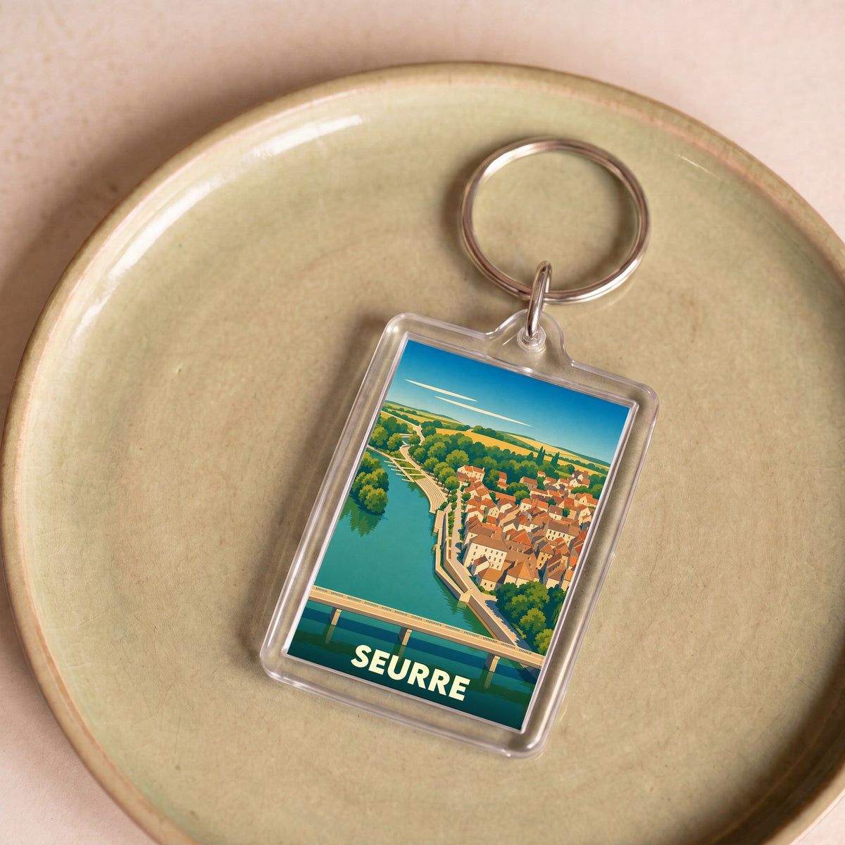 Porte-clés souvenir de la ville de Seurre avec une illustration stylisée.