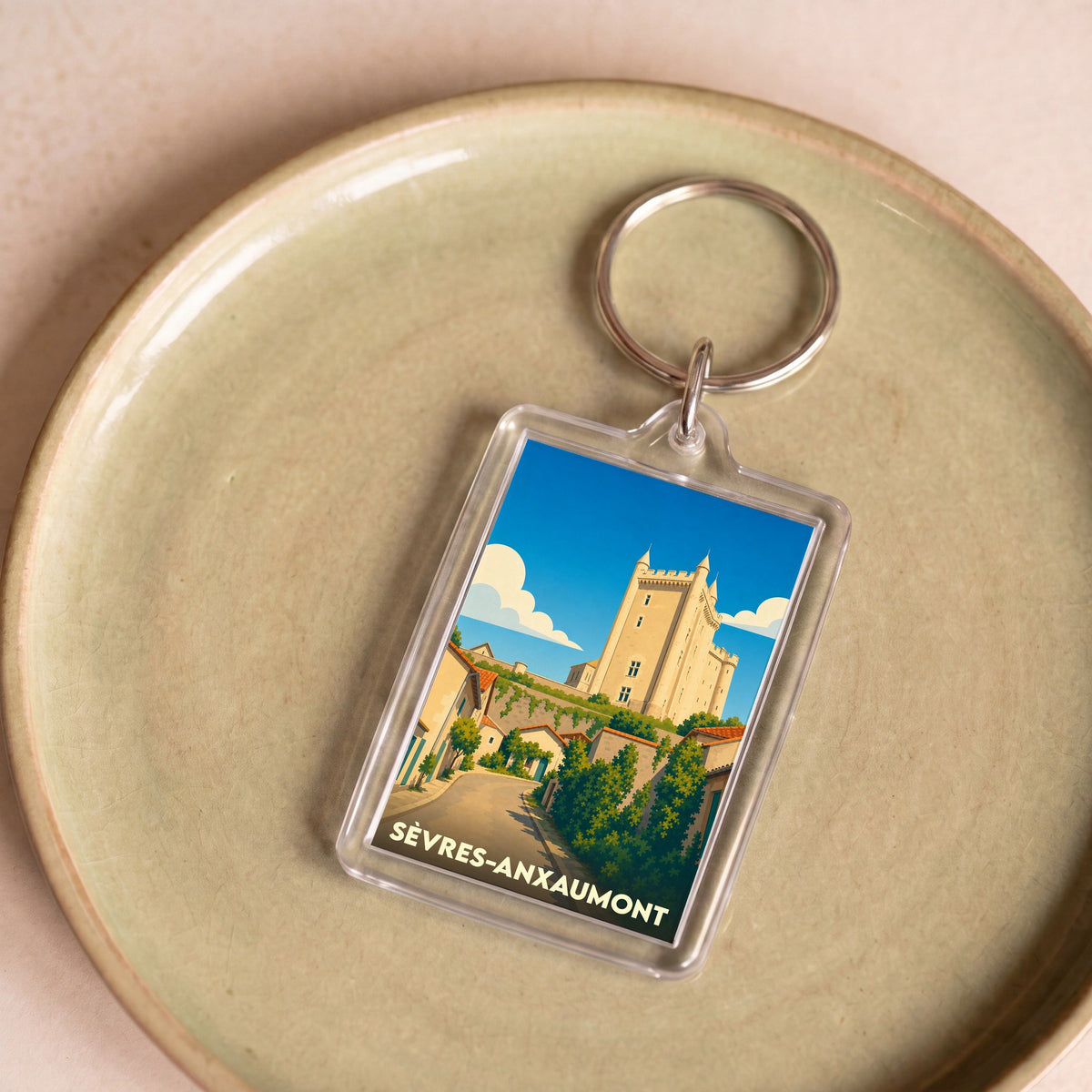 Porte-clés souvenir de la ville de Sèvres-Anxaumont avec une illustration stylisée d'un château.