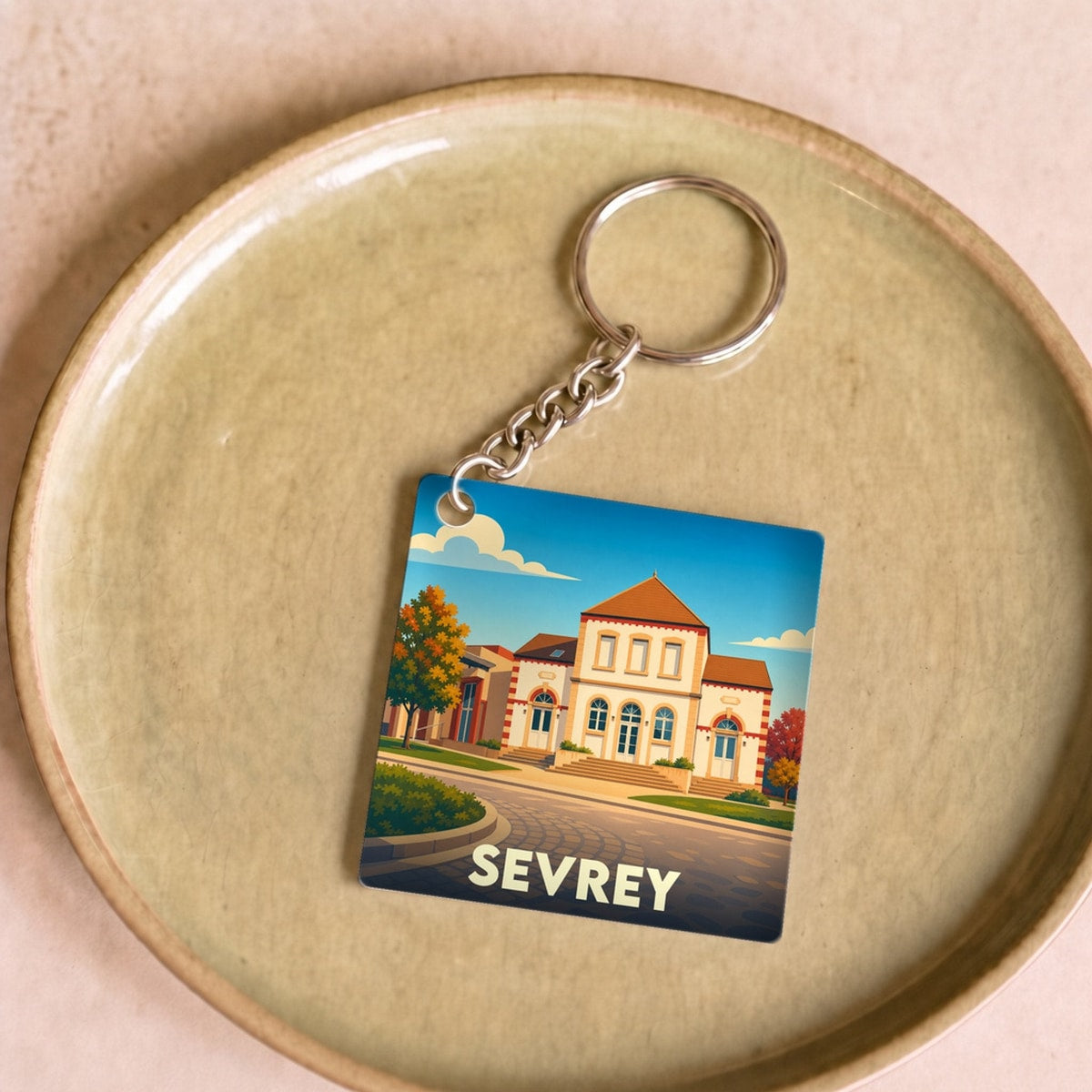 Porte-clés souvenir de la ville de Sevrey avec une illustration stylisée.