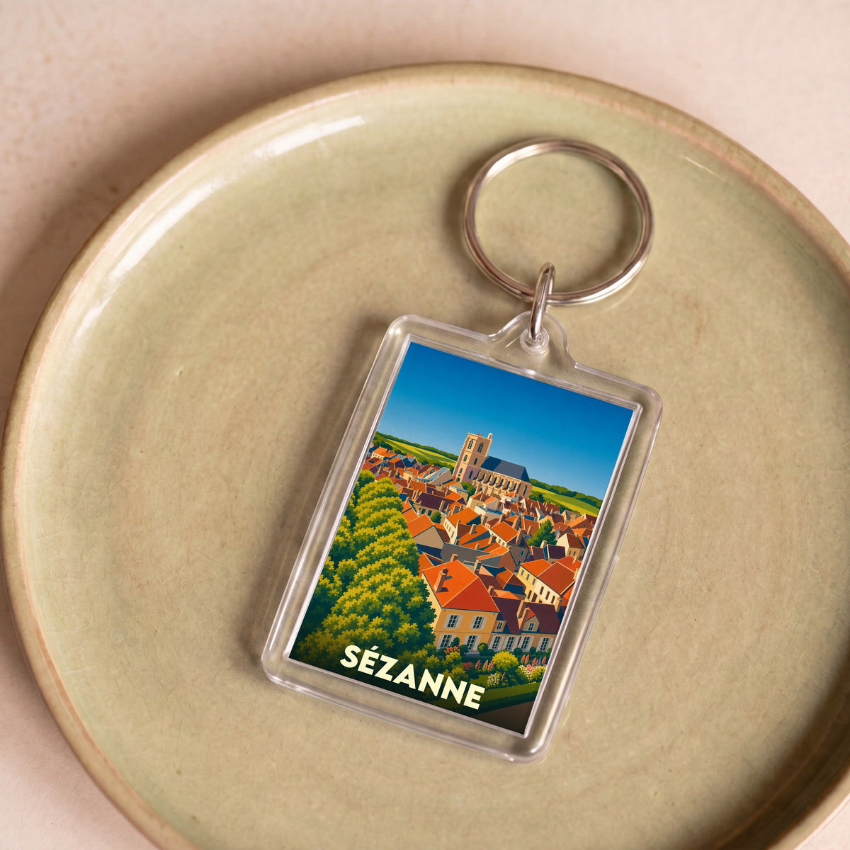 Porte-clés souvenir de la ville de Sézanne avec une illustration stylisée.