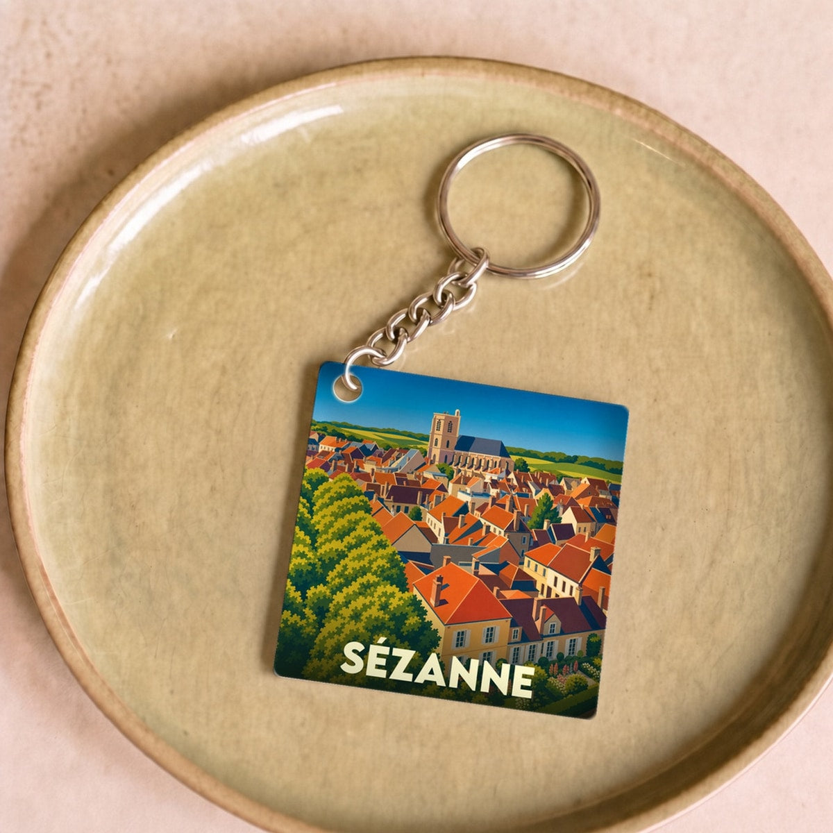 Porte-clés souvenir de la ville de Sézanne avec une illustration stylisée.