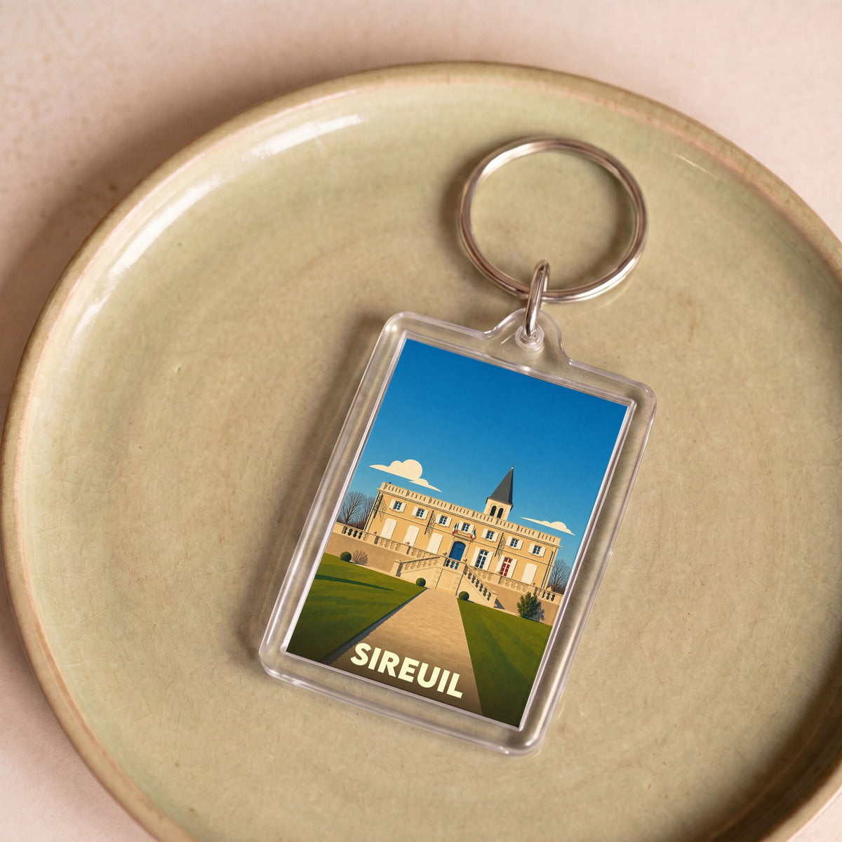 Porte-clés souvenir de la ville de Sireuil avec une illustration stylisée.